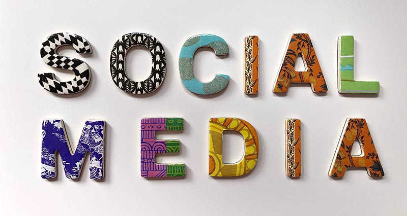 the words 'social media' in block letters that are different patterns and colors